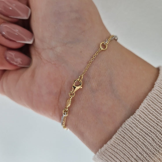 Armband tvåfärgat 18k guld med cubic zirconia stenar