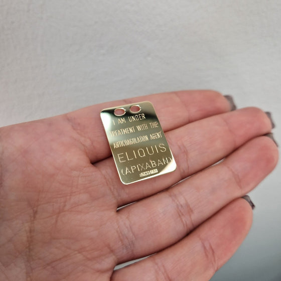 Eliquisbricka i 18k guld